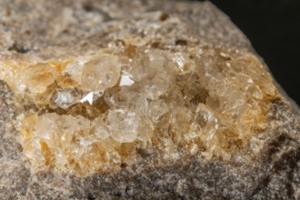 Translucent crystals shimmer in granite rocks. The discovery takes place in summer in a quiet,