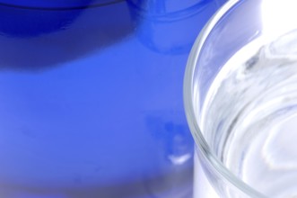 Glass with mineral water, small carbonated pearls on the edge of the glass, drinking water