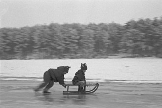 Children ride sledges on ice rink, Bleckede, Lower Saxony, Germany, January 04, 1995, vintage,