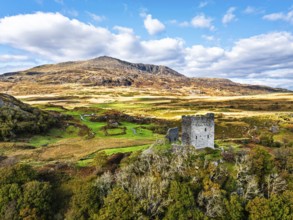 Autumn colours over Castell Dolwyddelan and Eryri Mountains from a drone, Snowdonia, Conwy County