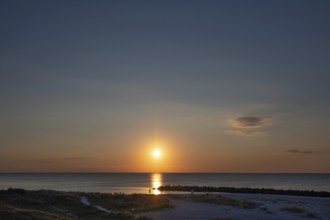 Sunset on the Baltic Sea with protective breakwaters, Darß, Ahrenshoop, Mecklenburg-Western