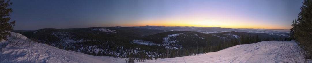 View from Mount Lusen over the hills of the bavarian forest at sunrise in winter, Bavaria, Germany