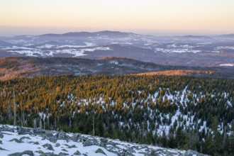 View from Mount Lusen over the hills of the bavarian forest at sunrise in winter, Bavaria, Germany