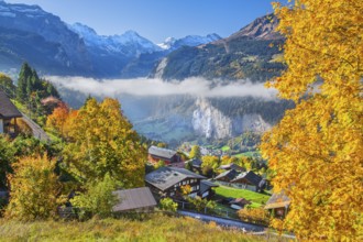 View from the village of the Lauterbrunnen Valley with Staubbach waterfall in autumn with morning