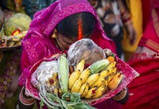 Hindu devotees gather on the banks of the Brahmaputra River to offer prayers to the Sun God on the