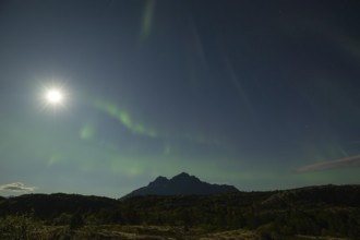 National mountain of Norway - Stetind in the Nordland under auroras and a full moon