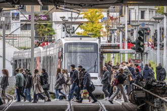 Pedestrians cross the tram tracks, at Düsseldorf-Bilk station, junction of S-Bahn, subway, tram,