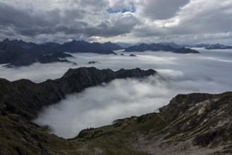 View from the Nebelhorn summit to mountains of the Allgäu Alps, mountains rising from fog in the