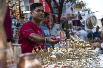 People shop for bronze and other metal items at a roadside stall on Dhanteras, in Guwahati, Assam,
