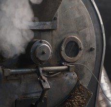 Machine for roasting coffee beans called roaster with a special automatic mixing device at work in