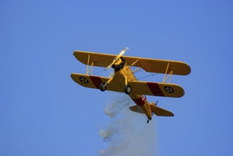 A Boeing-Stearman biplane during a flight demonstration as part of an air show at the Rossfeld in