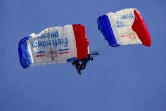 Two parachutists during an aerial acrobatic performance as part of an air show at the Rossfeld in
