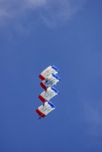 Parachutists during an aerial acrobatic demonstration as part of an air show on the Rossfeld in