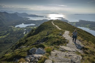Woman with hiking poles walking up Rørsethornet stone stairs, with 3292 steps one of the longest