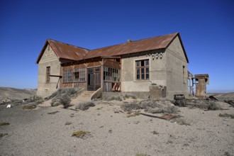 Dilapidated building in the desert sand, Pomona, restricted diamond area, near Lüderitz, Karas