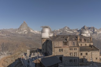 This breathtaking view shows the iconic Matterhorn mountain rising behind a historic observatory