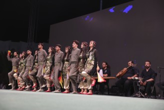 A Kurdish traditional dance troupe performs during the Damascus International Fair, the first