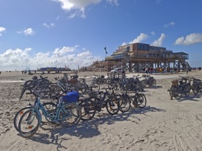 Car park for bicycles on the North Sea beach, Pfahlbau Strandbar 54° Nord, summer, sun, sand, on
