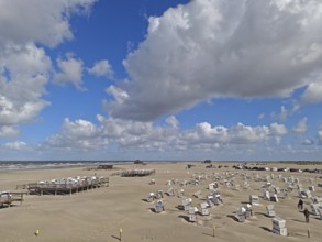 North Sea beach with sand drifts, car park, blue sky, white clouds, summer, sun, beach chairs, on