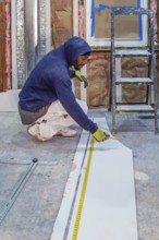 Detroit, Michigan - Workers remodel a house in the Morningside neighborhood that had been vacant