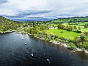 Farms and mountains over Ullswater Lake from drone, Pooley Bridge, Lake District National Park,