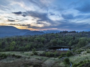 Sunset over Mountains and Coniston Water from drone, Lake District National Park, Cumbria, England,