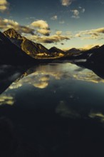Sunrise with reflections and alpenglow in Lake Heiterwanger See in Tyrol in the Alps in Austria
