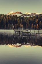 Lake Staz near Sankt Moritz in the Engadin in Switzerland. Morning atmosphere with fog in autumn.