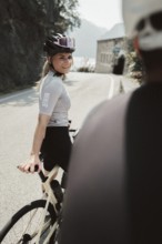 Woman and man cycling on Lake Garda in Italy. Sunny weather and dolce vita