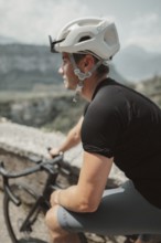 Young man riding a racing bike on Lake Garda. Sunny weather and dolce vita