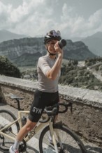 Young woman riding a racing bike on Lake Garda. Sunny weather and dolce vita