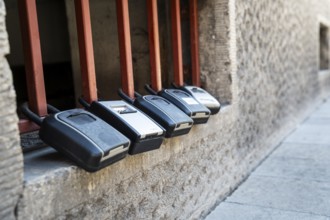 Key boxes on a grille of a basement window for flat flats in the city centre of Bratislava,