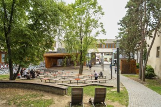 Small park with seating, a playground and a fountain at the entrance to Trencin Castle, Capital of