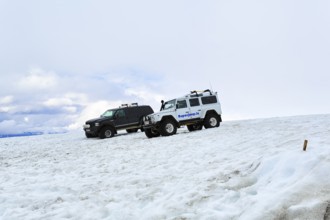 Two super jeeps parked next to each other in deep snow, glacier tour, Langjökull glacier, Husafell,