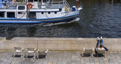 Promenade with chairs on the banks of the Spree from the Humboldt Forum, Berlin, Germany