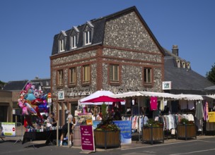 Weekly market with regional products, behind it co-operative bank, savings bank Crédit Agricole,