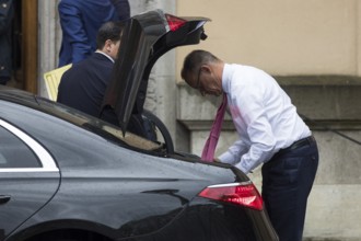 Friedrich Merz (CDU, German Chancellor) takes something out of a car boot in front of the joint