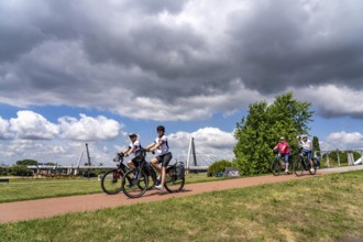 Cycle path in the Neulandpark in Leverkusen on the Rhine, in the background the new Rhine bridge of
