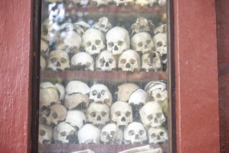 Shrine with human skull, memorial to the victims of the Khmer Rouge regime, Wat Thmei, Siem Reap,