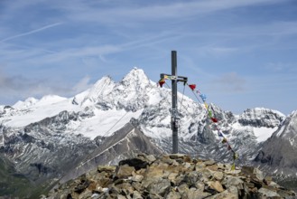 Summit cross of the summit Böses Weibl, behind summit of the Großglockner with snow, Schober group,