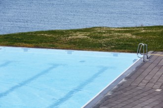 View from above of swimming pool by the sea, thermal bath, heated outdoor pool in Hofsos at the
