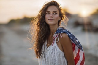 Beautiful attractive patriotic young woman with the American flag held in her standing in the