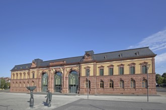 Old Post Office built in 1893 and sculpture of a woman wearing shoes, monument to the former shoe