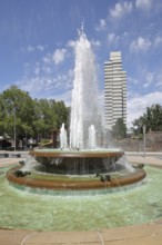 Round torch fountain by Friedrich Korter 1939 and town hall, water fountain with water basin, water