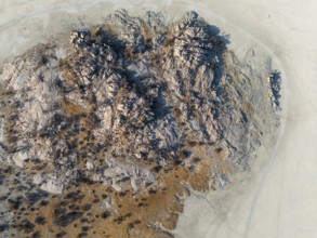 Rocky island with baobab trees in a dry salt pan, top down, aerial view, Kubu Island, Botswana