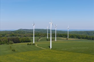 Row of wind generators on an undulating landscape with clear sky, Swabian Alb, Baden-Württemberg,