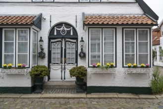 Beautiful ornate door, mullioned window, façade, old town, Husum, North Frisia, Schleswig-Holstein,