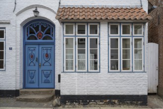 Beautiful ornate door mullion window, facade, old town, Husum, North Frisia, Schleswig-Holstein,