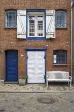 Window with shutters, brick façade, warehouse building, old town centre, Husum, North Frisia,