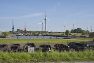 Old barges, shipyard, wind turbines, Dockkoog, Husum, North Frisia, Schleswig-Holstein, Germany